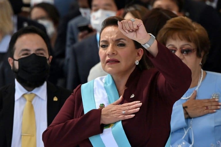 Leftist Xiomara Castro was sworn in Thursday as the first woman president of Honduras, vowing to reform the crime- and poverty-stricken nation into a "socialist and democratic state." Castro, 62, took the oath at a massive ceremony attended by international dignitaries after an embarrassing week of infighting in her Libre party that challenged her authority. In her first official address at the Tegucigalpa National Stadium, Castro denounced "the social and economic tragedy confronting Honduras" and promised to make work of improving education, healthcare, security and employment. She said she was inheriting a "bankrupt" country which she intended to reshape into a "socialist and democratic state." Honduras's public debt is about $17 billion. RTL Honduran President Xiomara Castro's supporters wait for her inauguration ceremony to begin in Tegucigalpa on January 27, 2022 / © AFP The oath was sworn before Judge Karla Romero, flanked by Castro's choice of Congress president, Luis Redondo, who draped the presidential sash over his new boss before a crowd of some 29,000. The guests included US Vice President Kamala Harris, King Felipe VI of Spain and Taiwan Vice President William Lai. - '12 years of struggle' - Castro's election last November brought an end to 12 years of right-wing National Party (PN) rule that followed the ousting of her president husband Manuel Zelaya in a 2009 coup. "Twelve years of struggle, 12 years of resistance. Today the people's government begins," Castro said on Twitter Thursday. RTL Honduras' new president, Xiomara Castro, promised to make work of improving education, healthcare, security and employment / © AFP But the lead-up to the swearing-in was marred by a disruptive rivalry within her Libre party, which is in a majority alliance in Congress. Libre factions split on who should be the legislature's new president, coming to blows in the Congress chamber and then holding rival inaugural sittings. Castro accused supporters of Redondo's rival for the Congress presidency, Jorge Calix, of being in cahoots with the PN and other forces she said wanted to undermine her anti-corruption drive. Juan Orlando Hernandez of the PN, her predecessor, is accused by US prosecutors of protecting drug traffickers in exchange for bribes. - 'Everyone wants to leave' - Castro assumes office with a full load of tasks ahead of her. Hondurans are fleeing the country in droves, often to the United States, in search of work and a better life. RTL Diplomatic ties with Taiwan / © AFP Castro spoke of a poverty rate of 74 percent, a figure she said "in itself explains the caravans of thousands of people of all ages fleeing to the north -- Mexico and the United States -- looking for a place and a way to survive in spite of the risk to their lives" from gangs and smugglers along the way. "Everyone wants to leave because there's no work. If there were more job opportunities here, there would be no need to look for another country," university student Jensi Davila told AFP in Tegucigalpa. Adding to the exodus, Honduras's murder rate is nearly 40 per 100,000 inhabitants. Among the crowd celebrating Castro's inauguration, seamstress Esther Lopez expressed hope that the situation "is going to change, because Xiomara has been supporting the cause of the poor for many hears and because of (her husband Manuel) 'Mel' Zelaya, who was a good president." - Migration talks - US Vice President Harris urged Castro to fight corruption, seen as a root cause of Central American migration, in talks after the inauguration ceremony. RTL Honduras Presicent Xiomara Castro (R) meets US Vice President Kamala Harris at the presidential house / © AFP Harris, the first foreign official to have a bilateral meeting with Castro, welcomed the priority the new president had placed "on countering corruption and impunity, including her intent to request the assistance of the United Nations in establishing an international anti-corruption commission," said a readout from Harris's office. Castro needs international support to renegotiate a foreign debt of some $11 billion. It is an issue, according to former prime minister Edgardo Paz, which requires agreement "with the multilateral institutions where Washington has a lot of influence." Harris said her visit would be an opportunity to boost cooperation on key issues "from the fight against corruption to economic recovery." Castro will also meet Lai, though separately, "to exchange views on issues of mutual concern," according to Taiwan's foreign ministry. Honduras is one of just 14 countries to recognize Taiwan. China, which considers Taiwan a part of its territory, has spent decades successfully encouraging its allies to switch sides. On the election campaign, Castro vowed to "immediately open diplomatic and commercial relations with mainland China" if she won. Castro announced part of her cabinet Thursday, with her son Hector Zelaya as private secretary and Jose Manuel Zelaya -- her husband’s nephew -- as defense minister. Honduras has no law against nepotism.