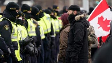 Photo of Canada police work to clear key border bridge as Ottawa protest again grows