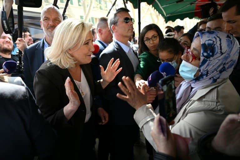 Macron clashes with Le Pen over Islamic headscarf ban