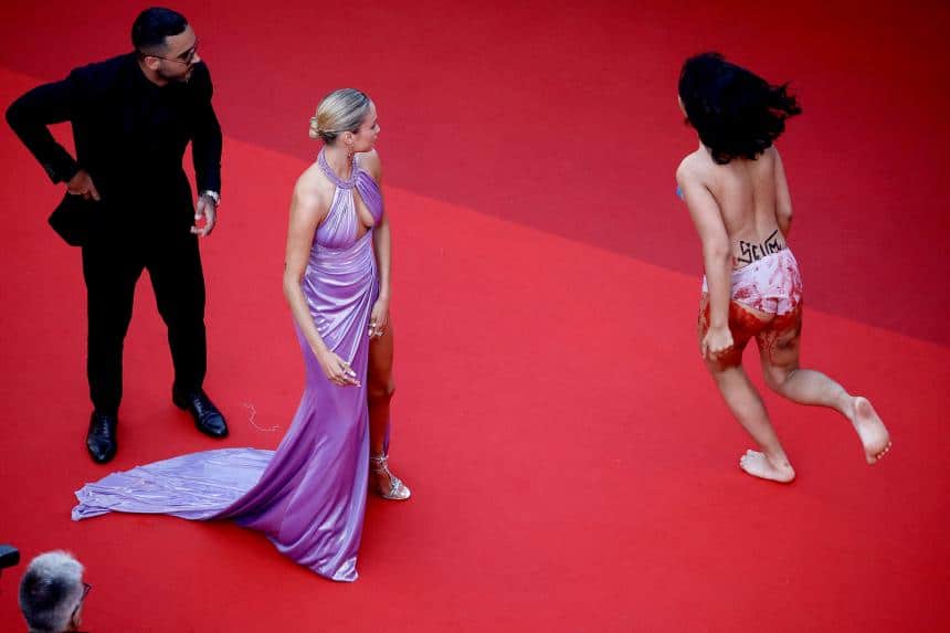 Woman storms Cannes red carpet to protest Ukraine rapes