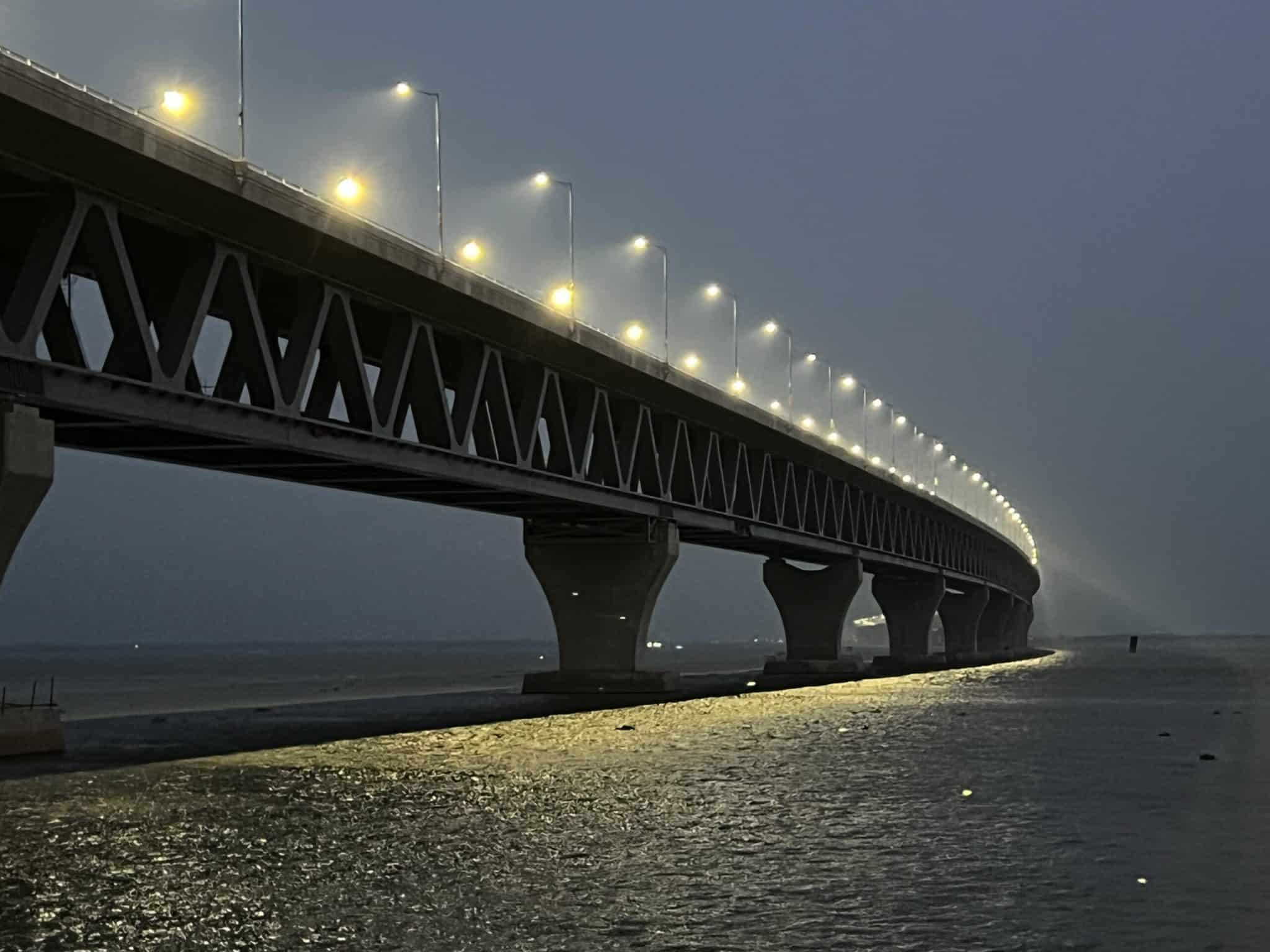 All 415 lampposts installed on the 6.15 kilometer Padma Bridge were lit up all together for the very first time at 6:30 pm today. Padma Bridge project director Shafiqul Islam lit up the bridge by switching on 175-watt LED lights at all the 415 lampposts of the Padma Bridge on trial basis. Later, sweets were distributed among local and foreign engineers. Our Munshiganj correspondent reports: A festive mood prevailed among the jubilant people living on the both sides of river Padma on the occasion. On Monday, all 207 lampposts installed in the Mawa point of the Padma Bridge were lit up all together at 5:30pm. Earlier on June 4, 24 lampposts installed between the 14th and 19th pillar of the bridge were illuminated on trial basis. Prime Minister Sheikh Hasina will inaugurate the bridge on June 25. The bridge will be opened up for vehicles on June 26.