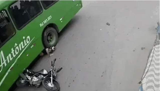 Brazilian biker slides under bus, comes out alive