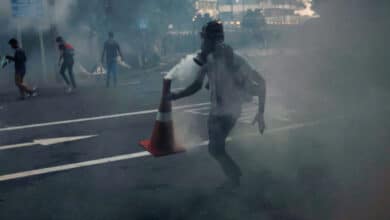 Photo of Sri Lanka imposes curfew as cops fire tear gas at protesters